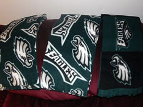 White Eagles symbol on a dark Eagles' green. Two scarves same colors, but one has smaller "Eagles" word and eagles head, so more green shows.
