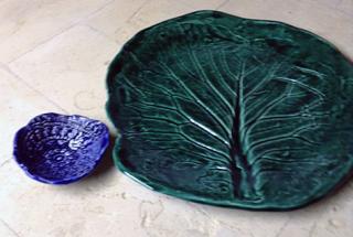 large green platter with leaf design and small blue bowl