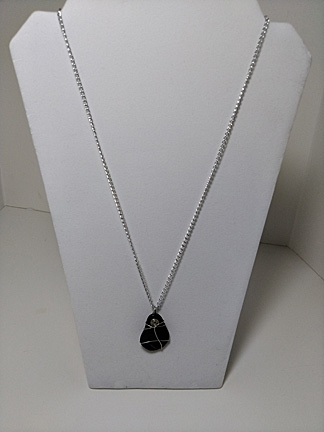 pendant of black teardrop flat stone on silvery chain