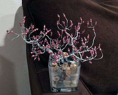 redbud in glass with rocks