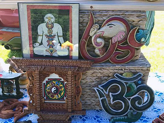 This picture is of several items that Duchovnay and Urbas create.  There is a painting/colored drawing of an Eastern religion god, and elephant head with designs, a 35 and a clock or plack.