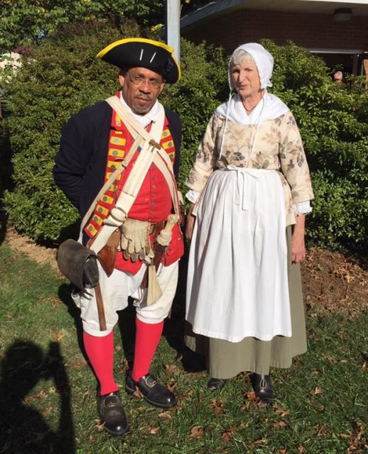 man and woman in colonial clothes