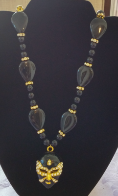 yellow gold and black necklace