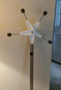 Shown is a vertical rod, with a spin-wheel wind-catcher.