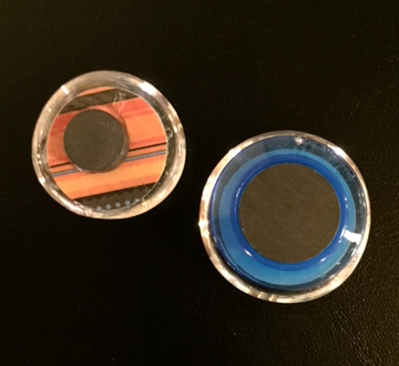 Shown here are the back-side of the glass magnets in the earlier picture.  One has a large magnet and the other has a smaller but deeper magnet. 