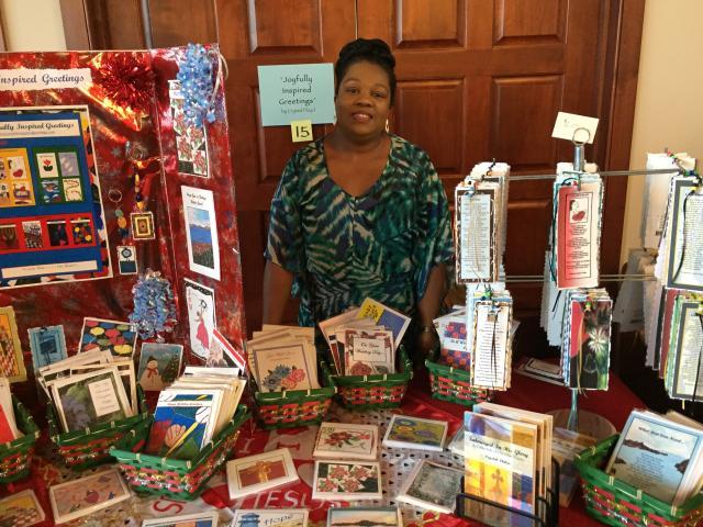 Crystal with her display of greeting cards and bookmarks